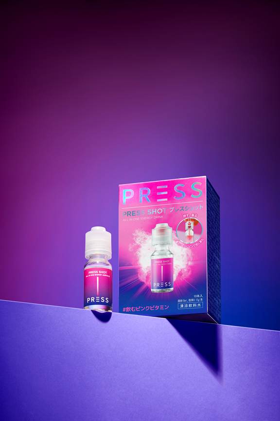 A close-up of a Presssshot inner beauty drink bottle and its packaging, showcasing vibrant colors against a gradient background.